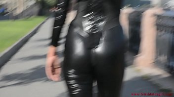 Latex Mona In A Sexy Suit And High Heels Walks Down The Street